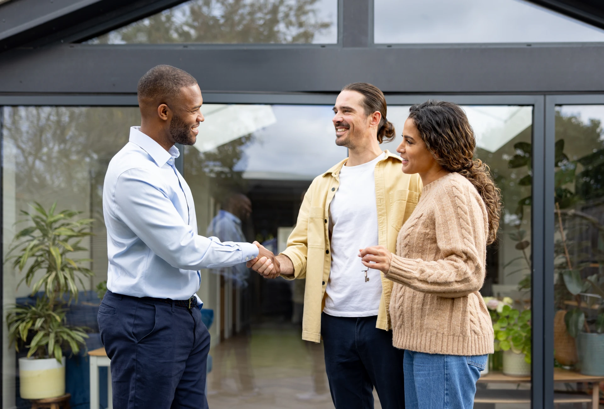 Friendly handshake between three people